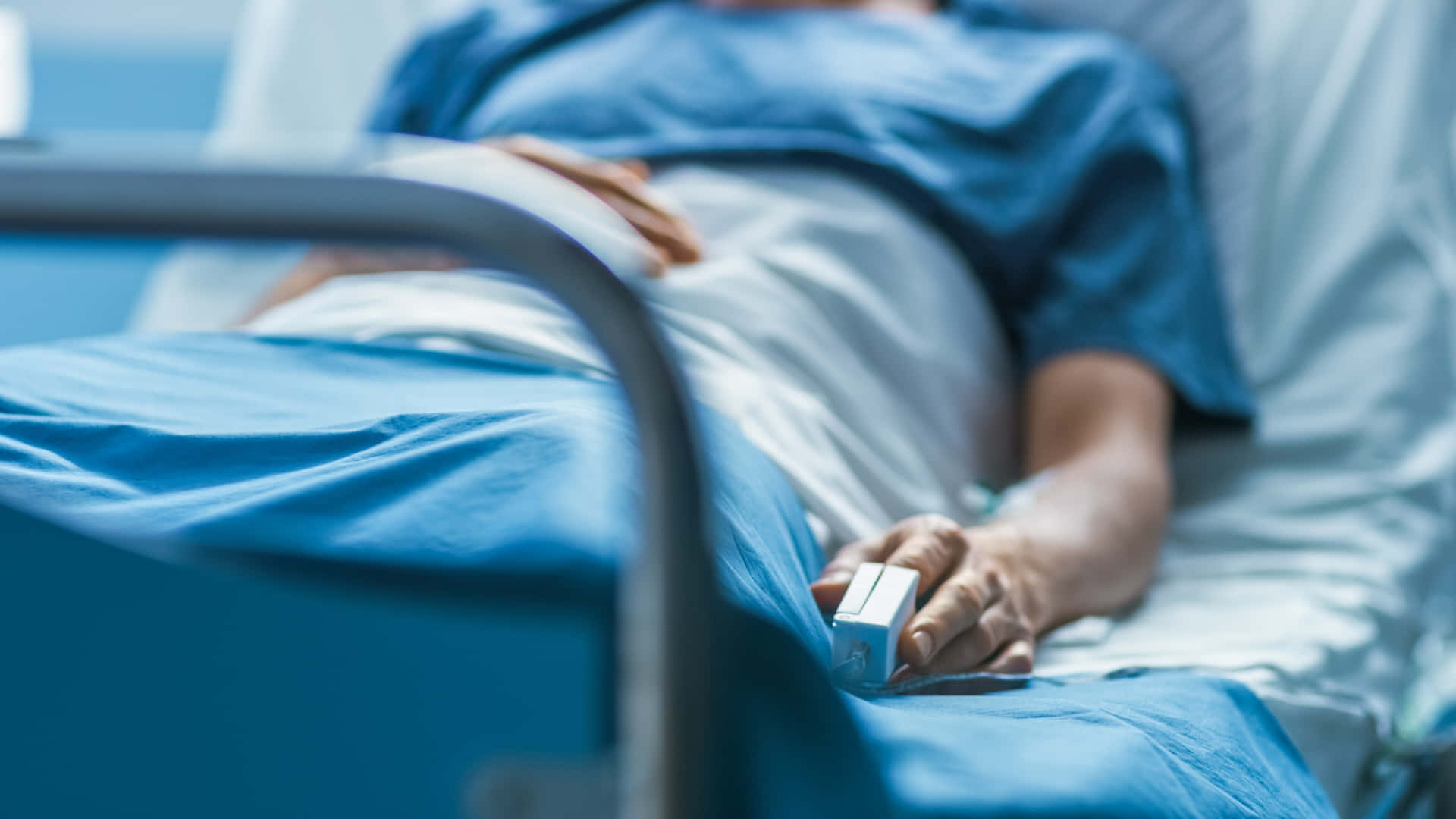 Patient Lying On Hospital Bed Wallpaper