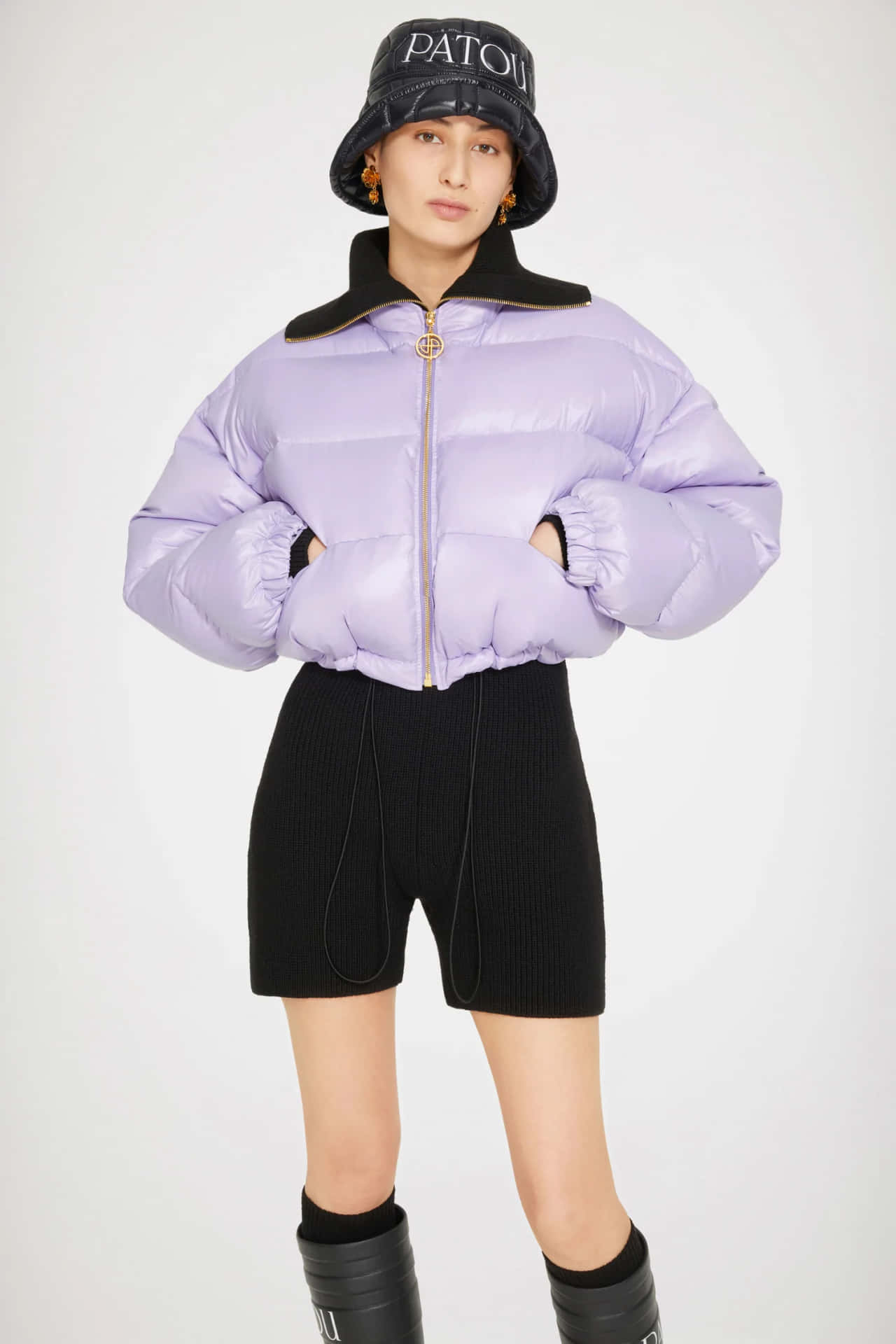 Stylish Woman in a Patou Purple Puffer Jacket Wallpaper