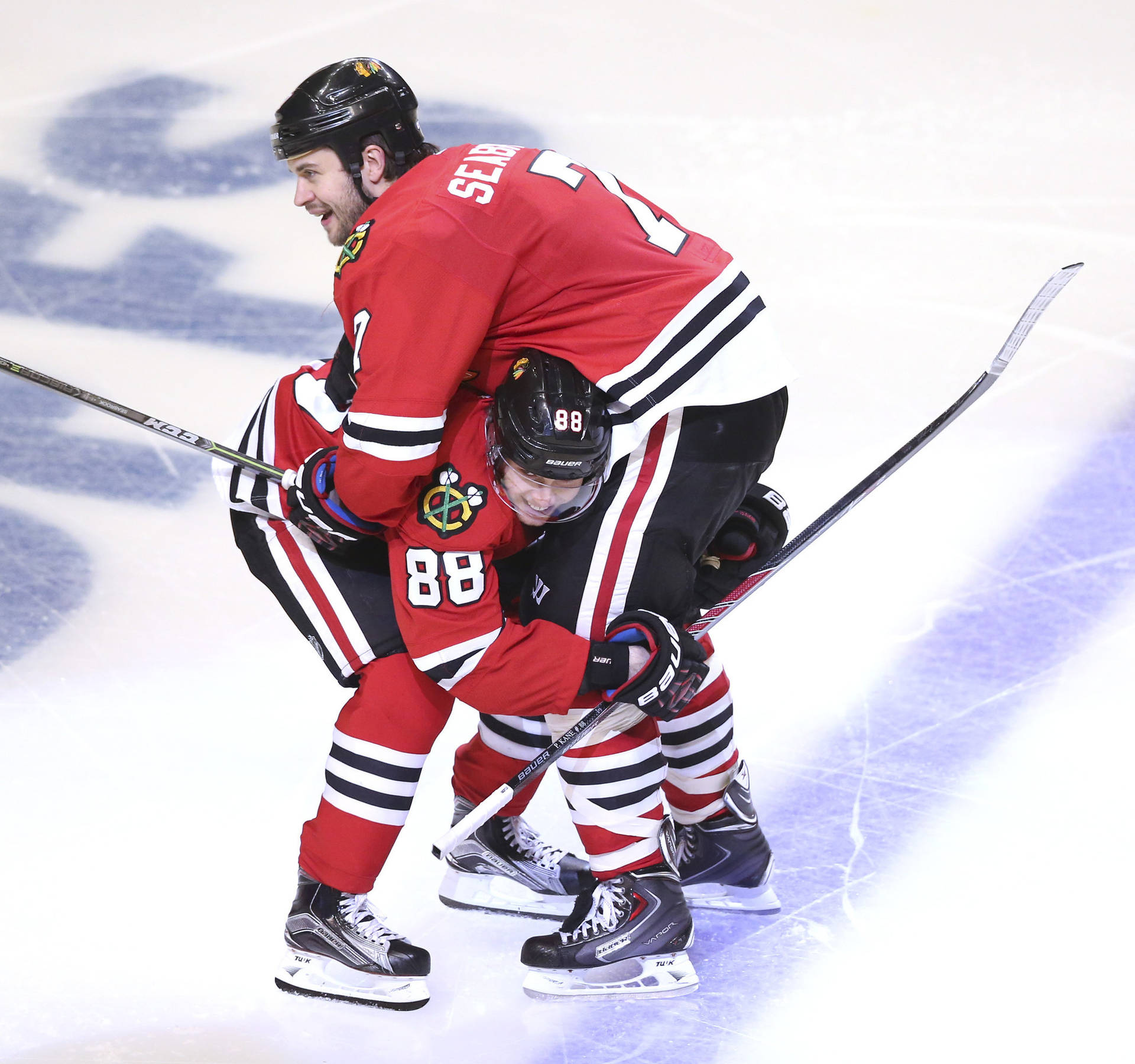 Brent Seabrook and Patrick Kane celebrating on the ice Wallpaper