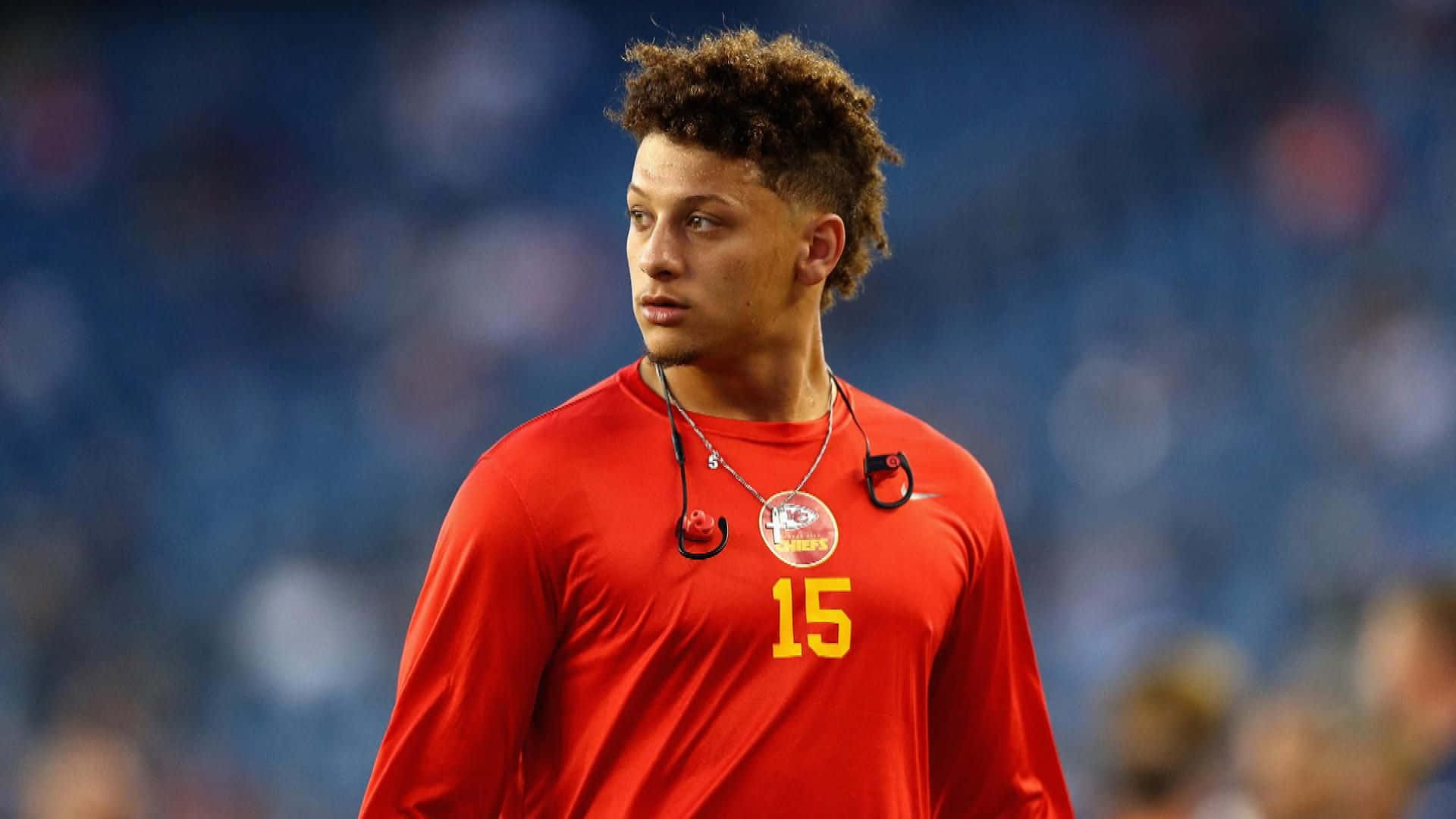 Patrick Mahomes in Kansas City Chiefs uniform, ready to execute an iconic pass