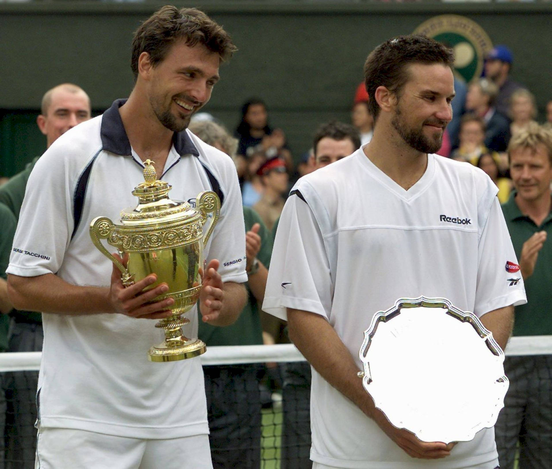 Tennis Legends Patrick Rafter and Goran Ivanisevic Sharing a Joyful Moment Wallpaper