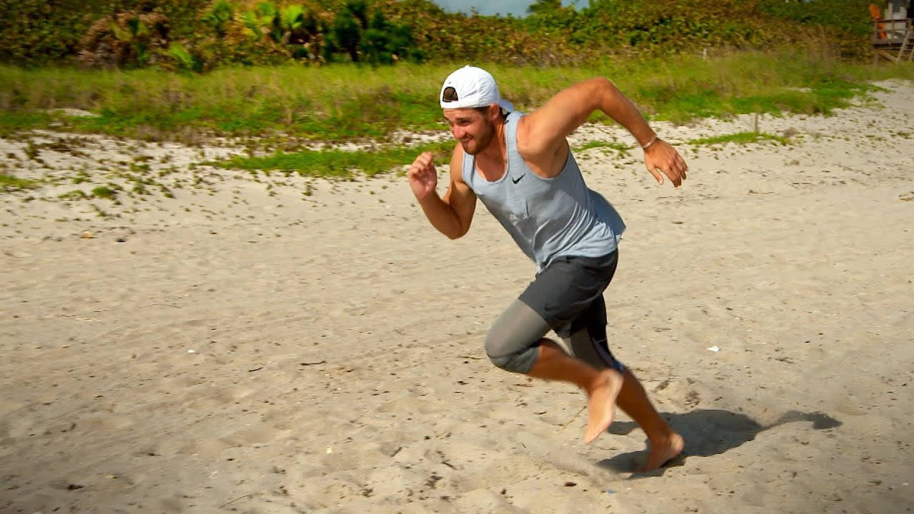 Patrick Rodgers Running On Beach Wallpaper