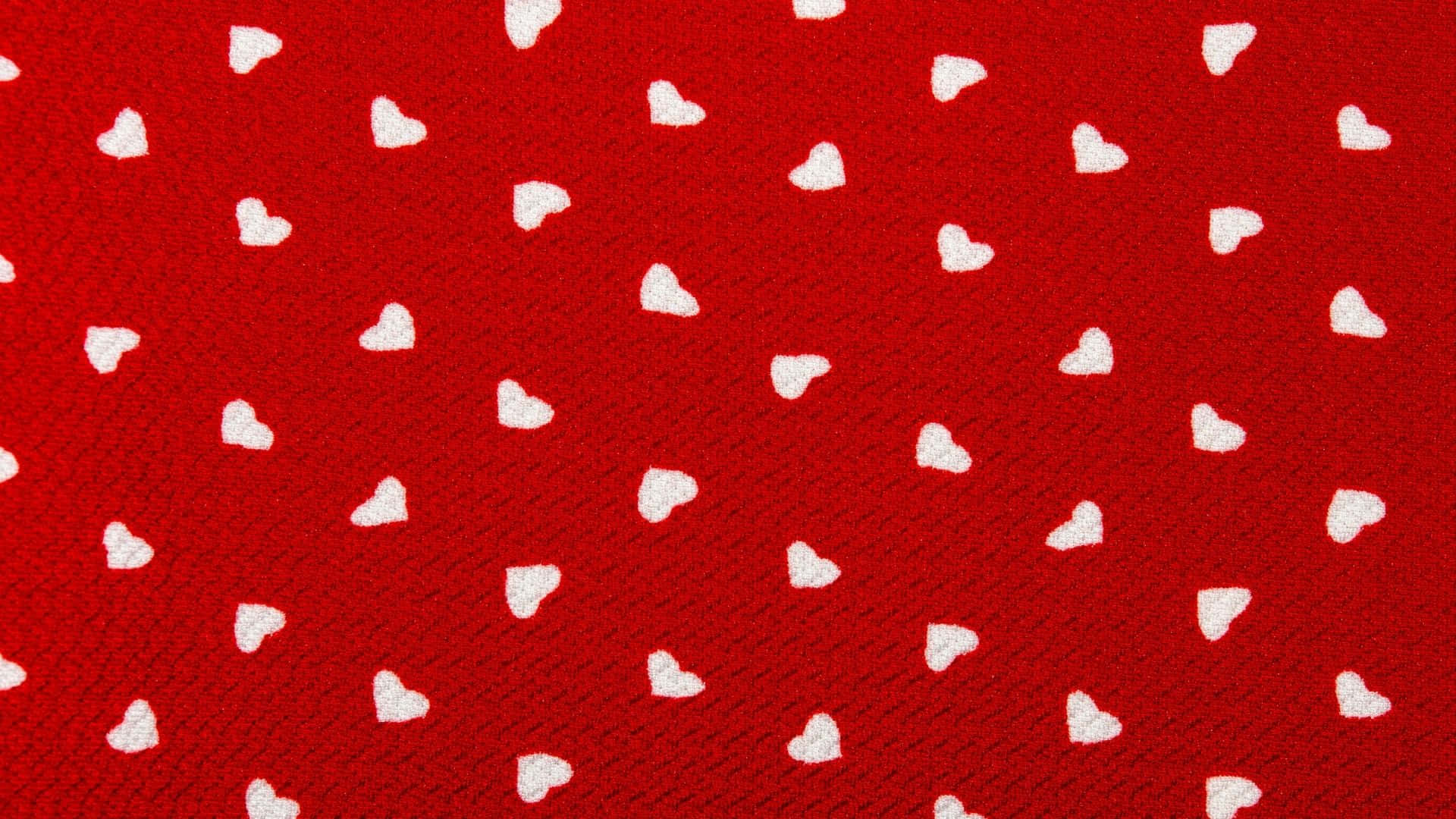red fabric with white hearts on it