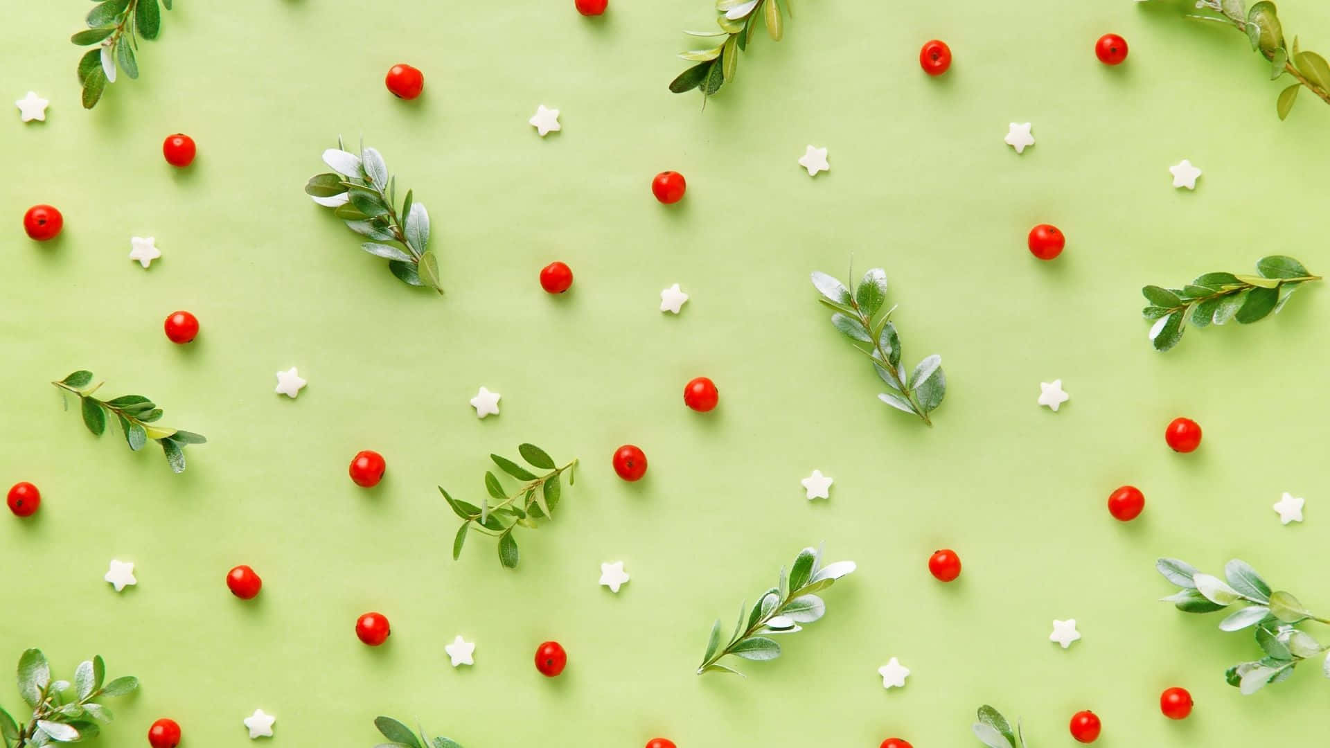 a green background with red berries and leaves