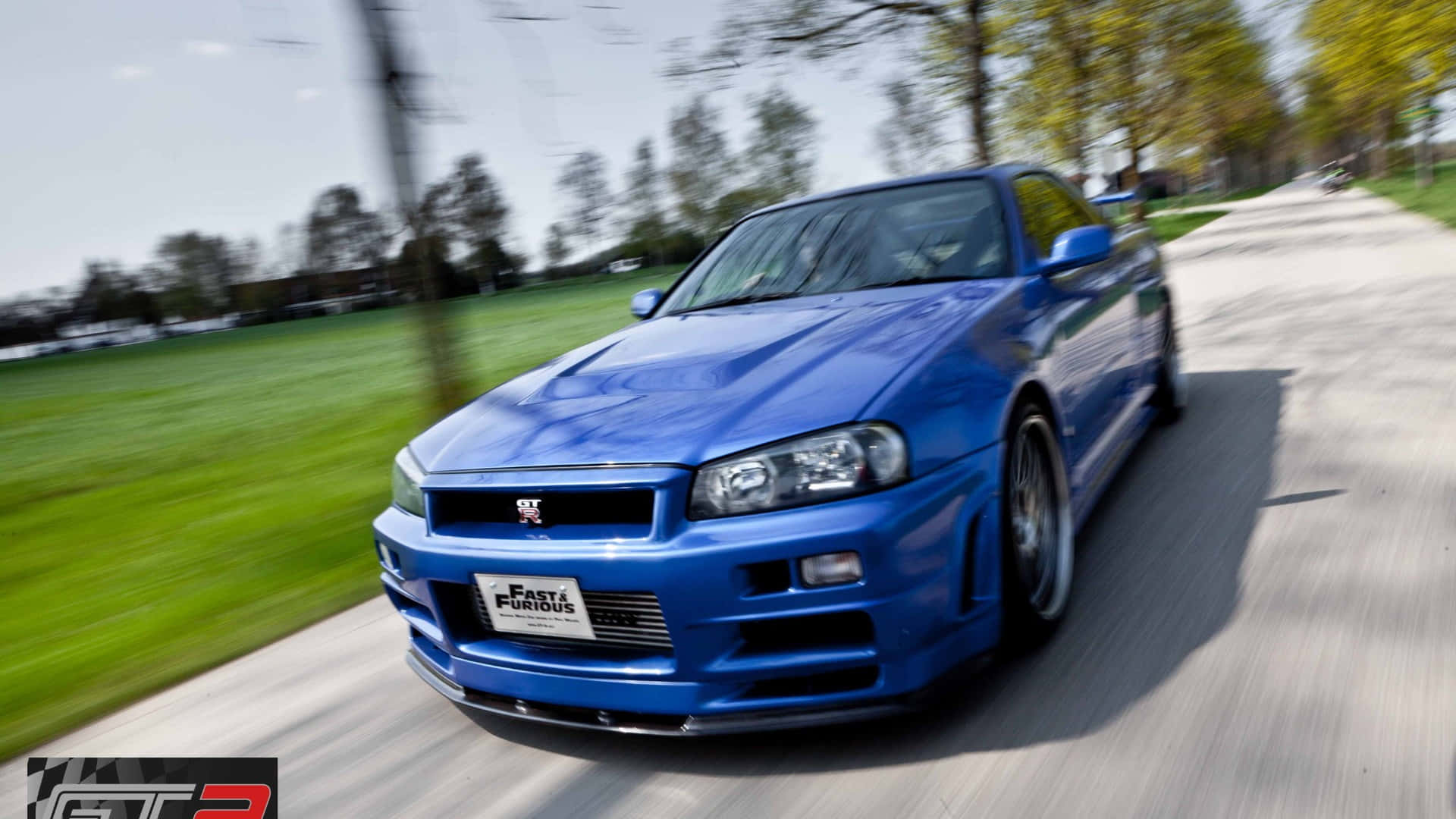 Paul Walker speeding down the highway in a fast and furious Nissan Skyline. Wallpaper