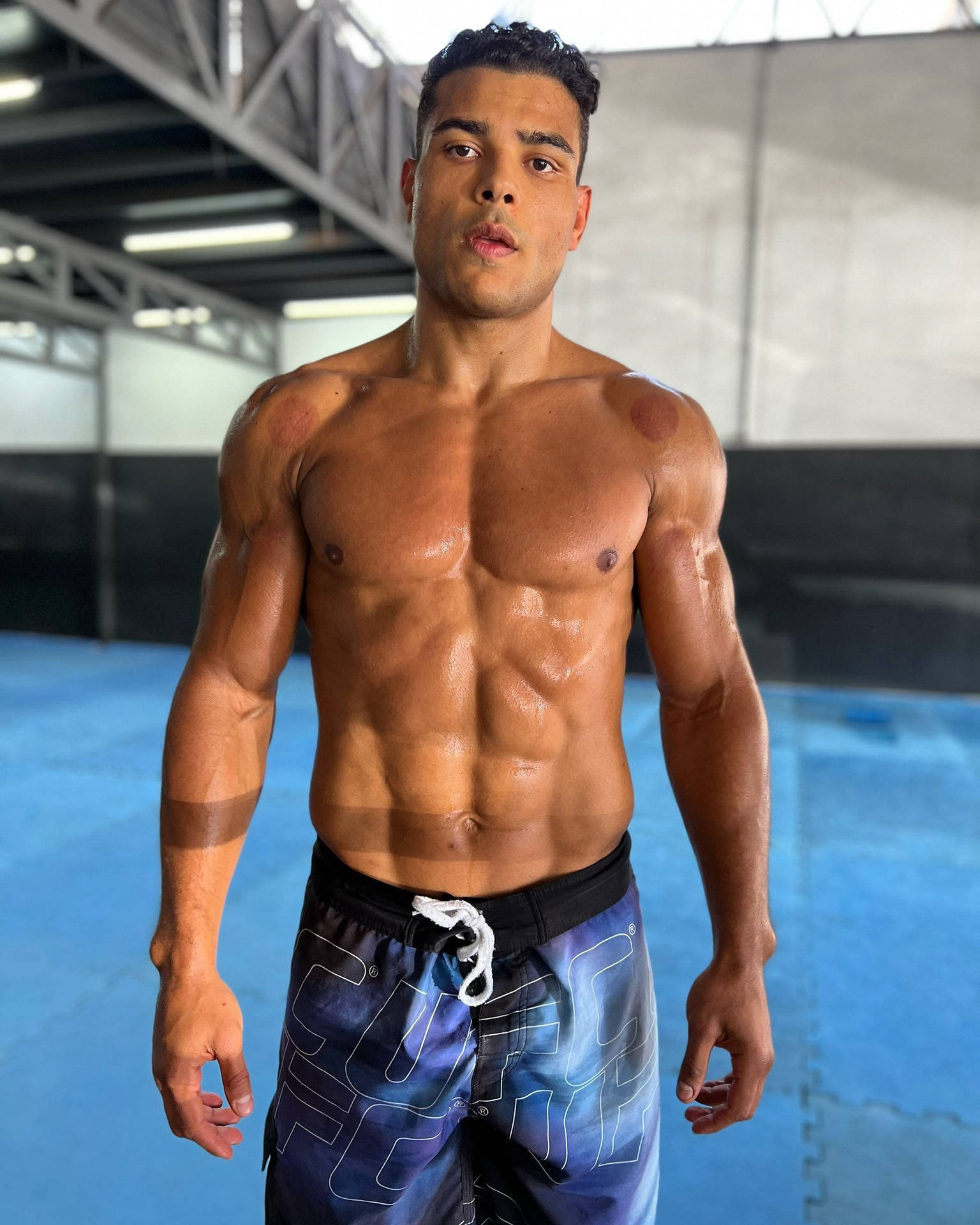 Paulo Costa Showing Abs Background