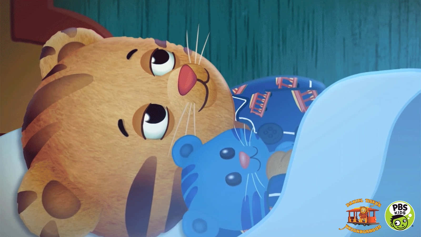 A Tiger Is Laying In Bed With A Blue Teddy Bear