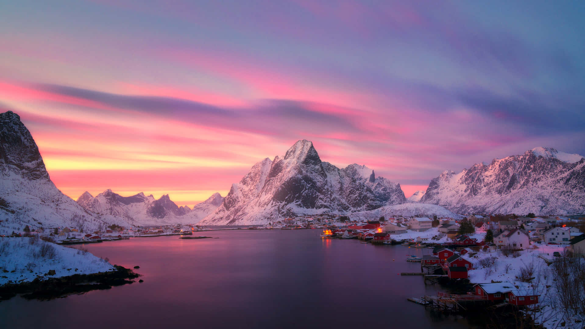 A Colorful Sunset Over A Snowy Mountain Range