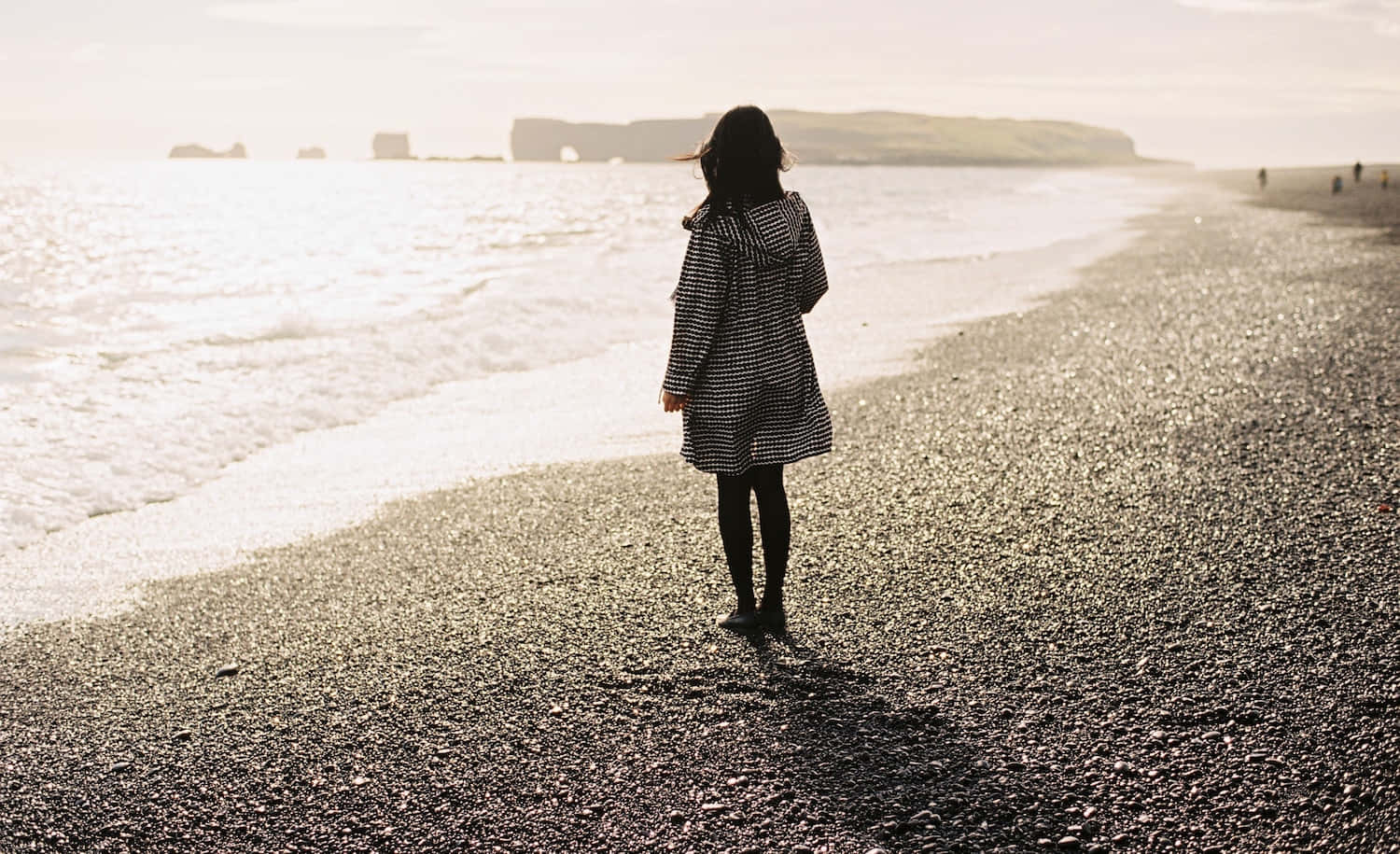 Woman Walking Along A Peaceful Beach Picture