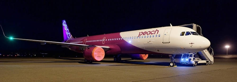 Peach Aviation Night Flight Wallpaper