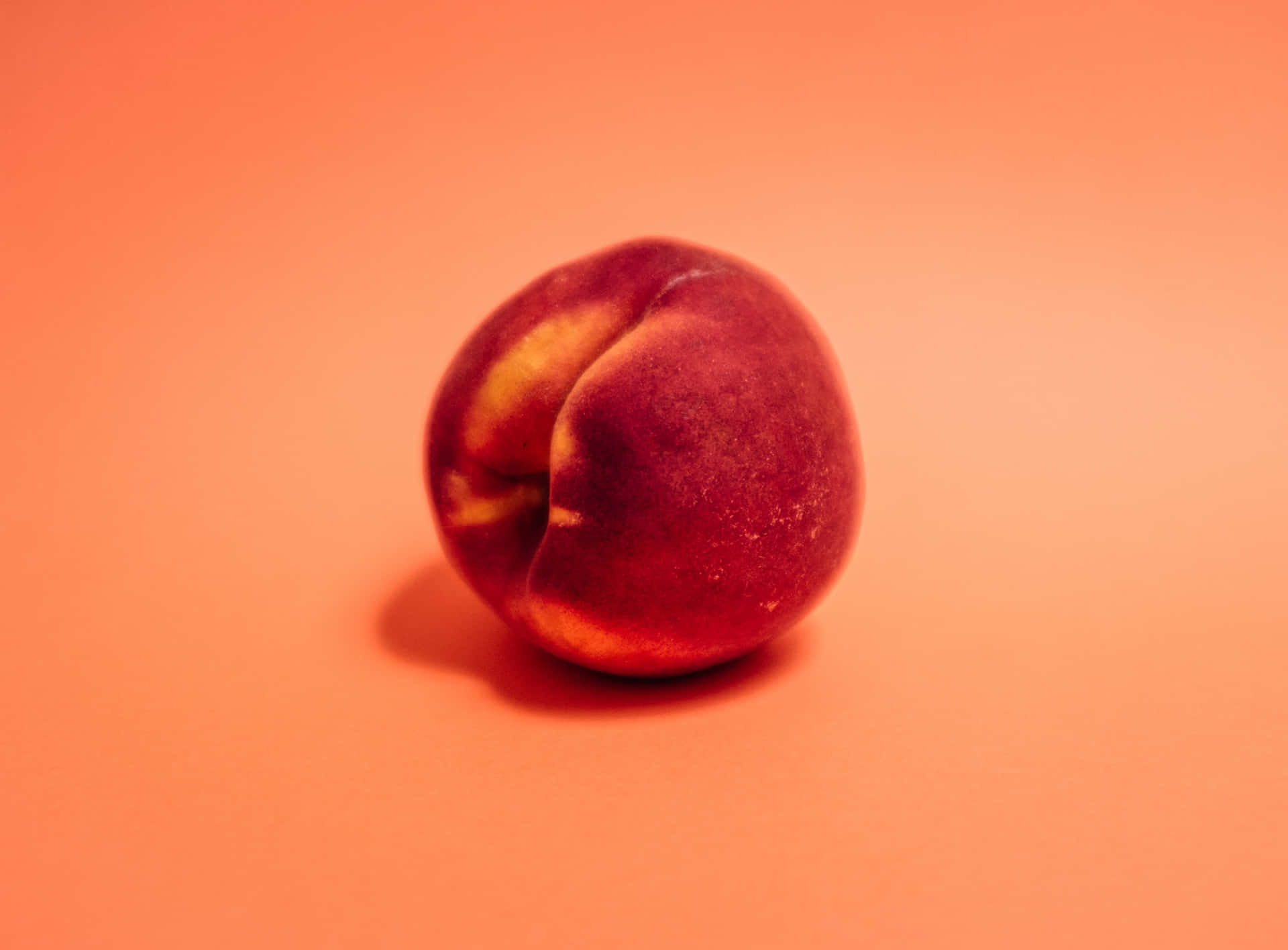 A Peach On A Red Background