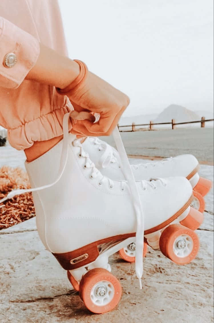 A Woman Wearing Roller Skates And Holding A Pink Shoe