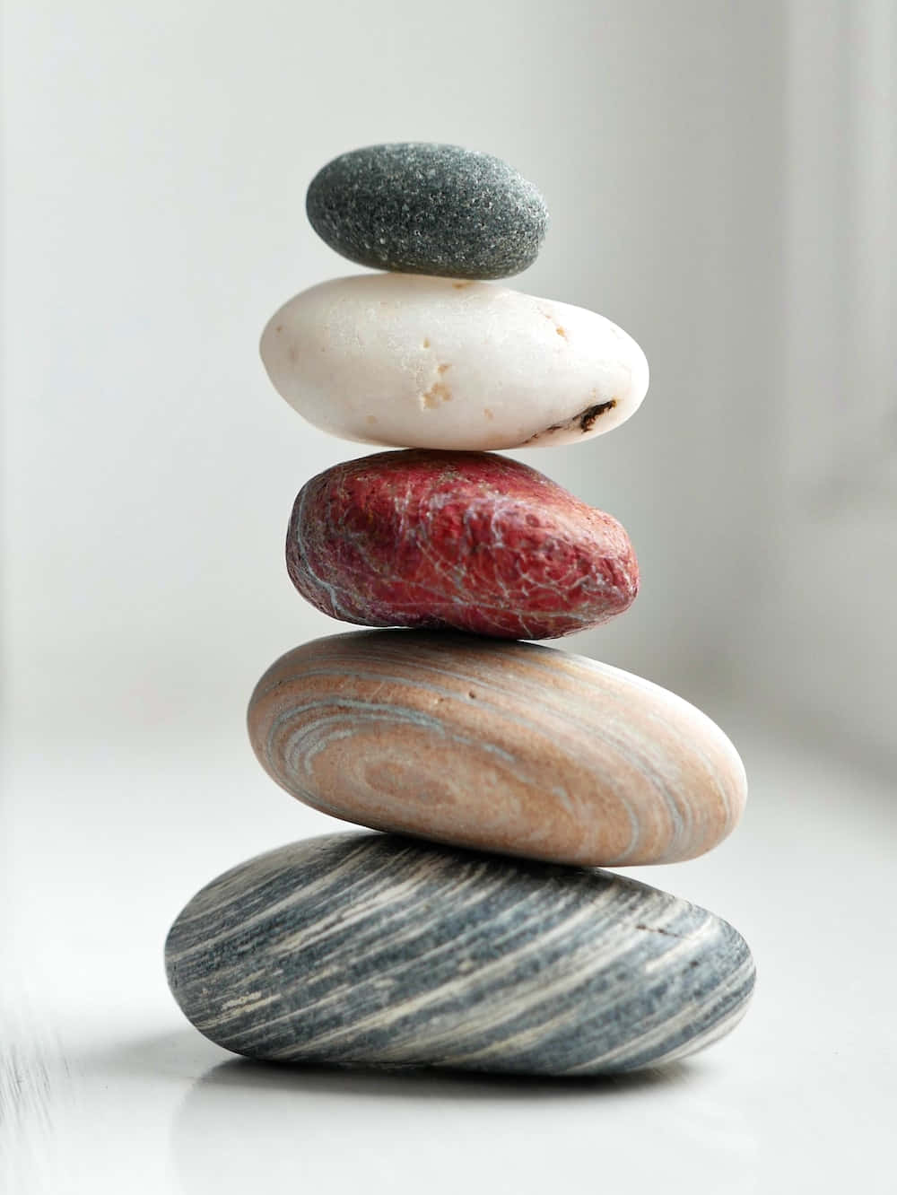 A Stack Of Stones On A White Table