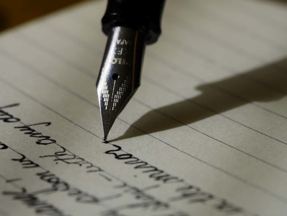 A Fountain Pen Is Writing On A Piece Of Paper