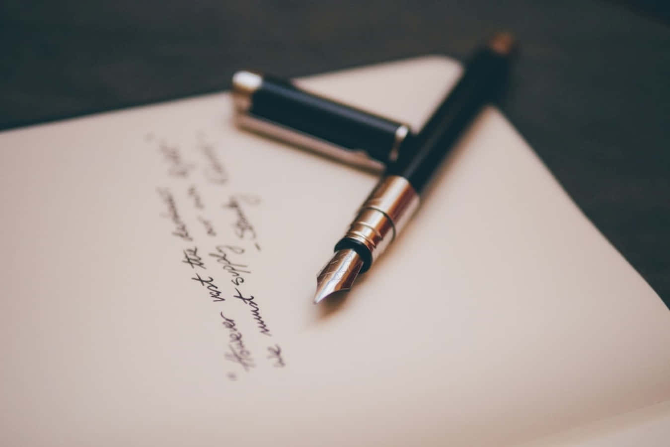 A Fountain Pen And A Notebook On A Table