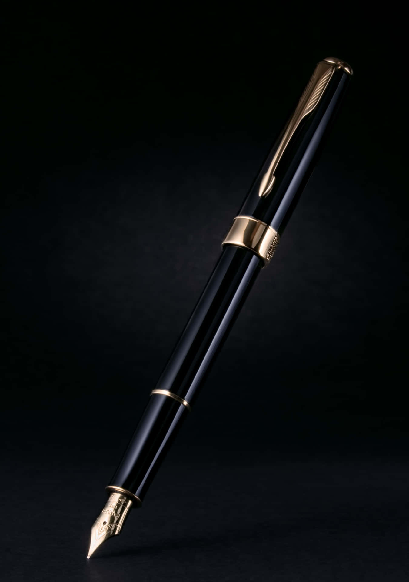 A Black And Gold Fountain Pen On A Black Background
