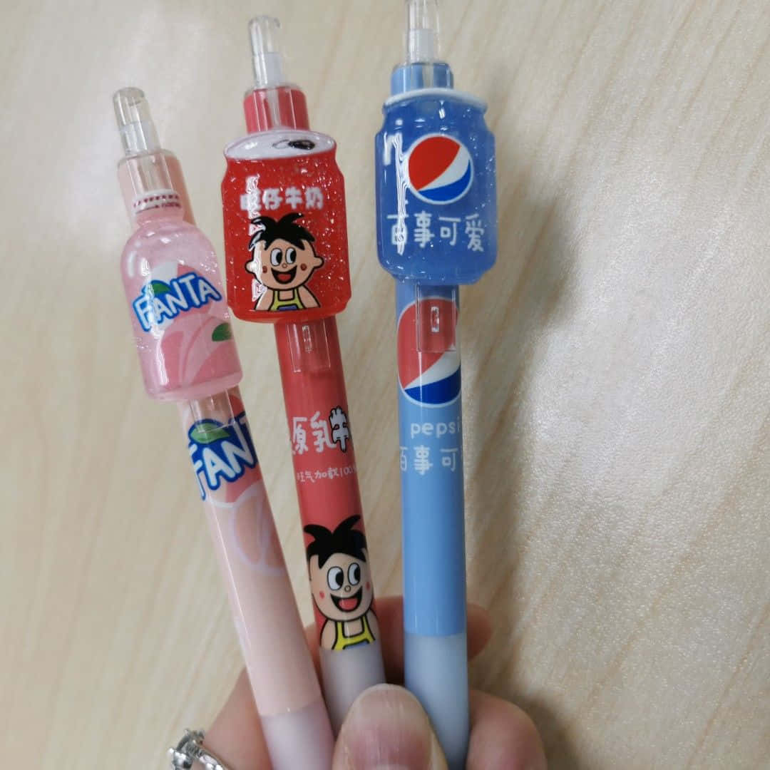A Person Holding A Pepsi Pen With Different Flavors