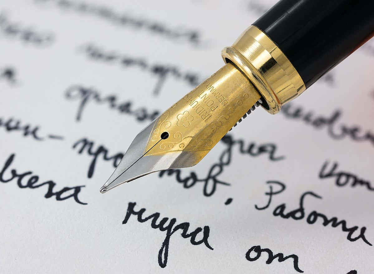 A Fountain Pen Is Writing On A Piece Of Paper