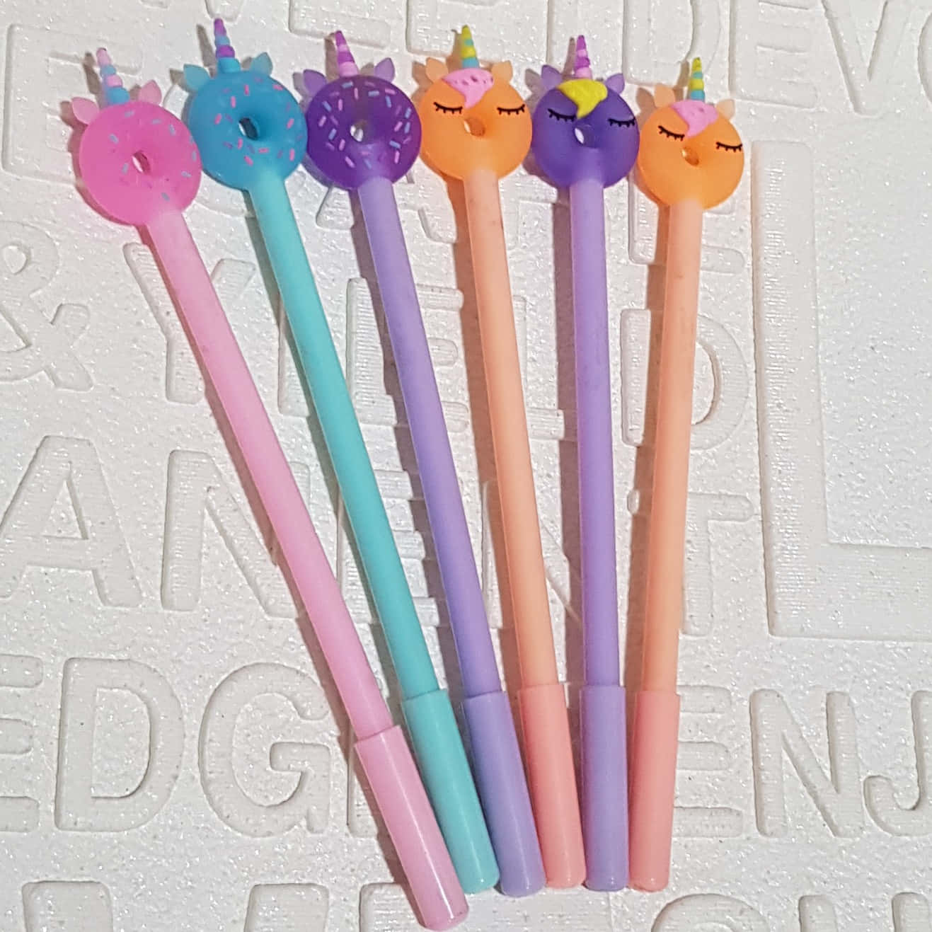Five Colorful Unicorn Shaped Pens Are Sitting On Top Of Each Other