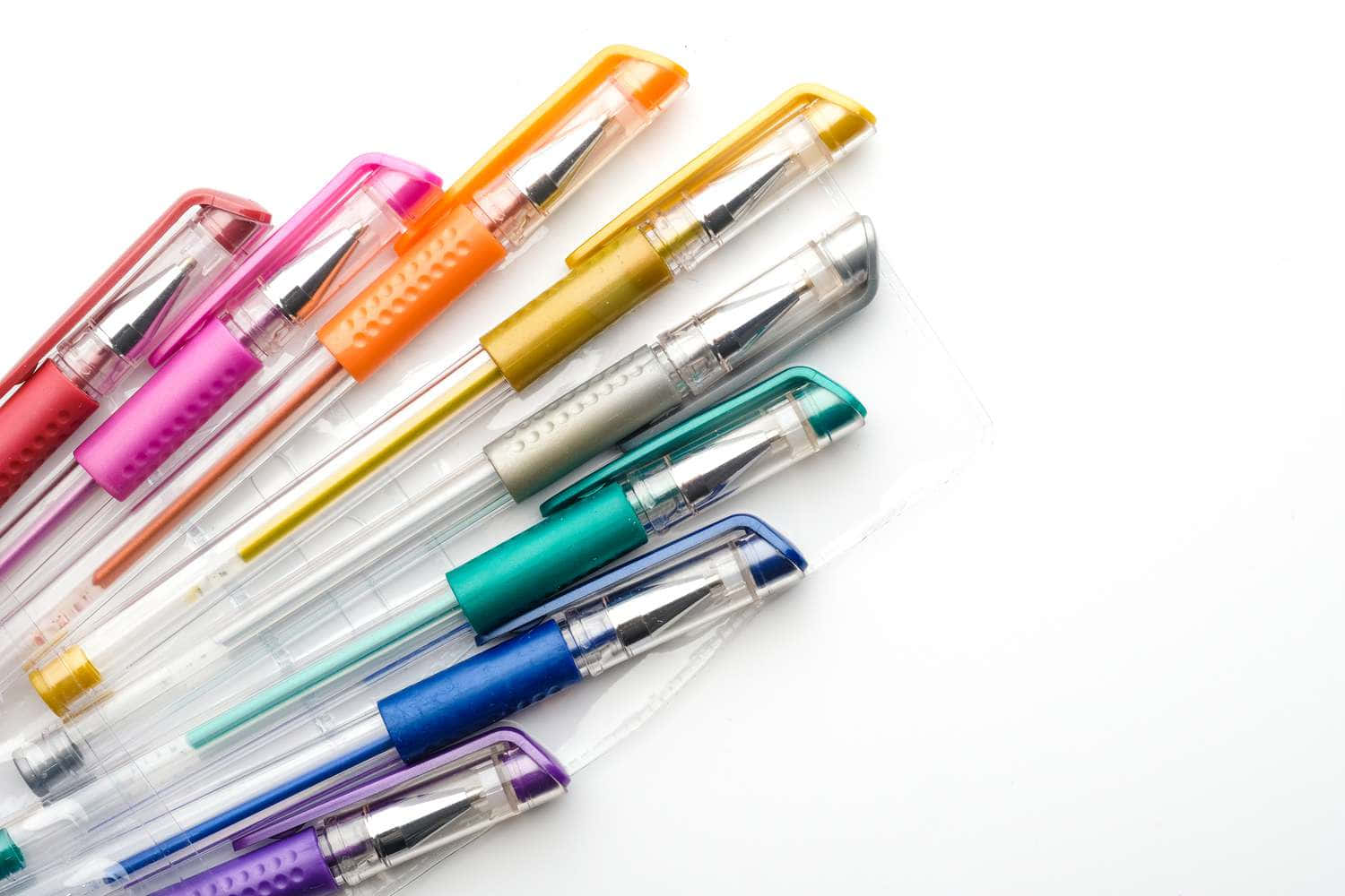 A Group Of Colorful Pens On A White Background