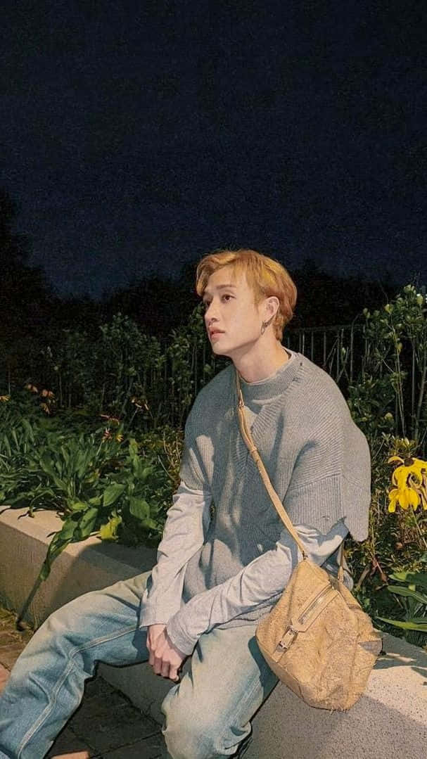Pensive Man Nighttime Garden Wallpaper