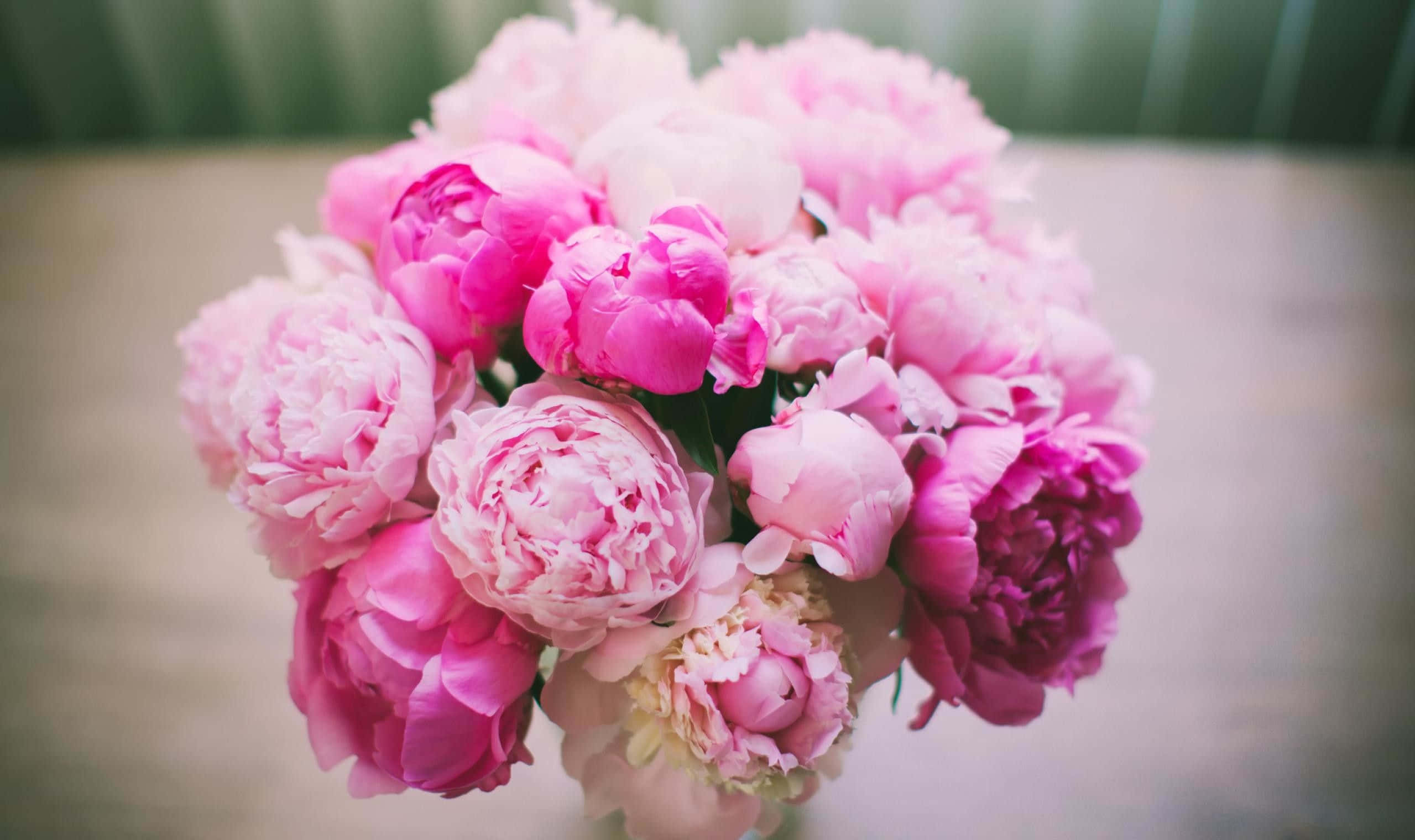 Pink Peonies In A Vase On A Wooden Table