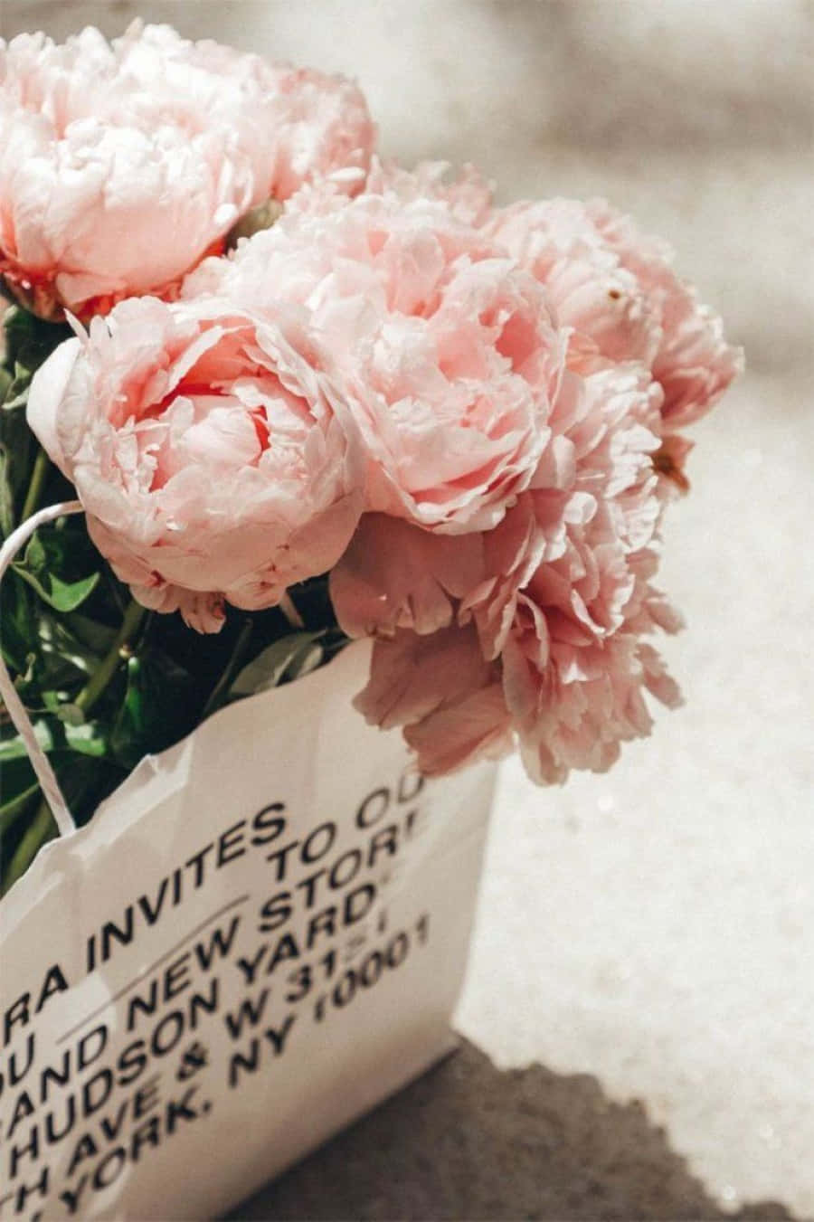 A Pink Paper Bag With Flowers In It Wallpaper