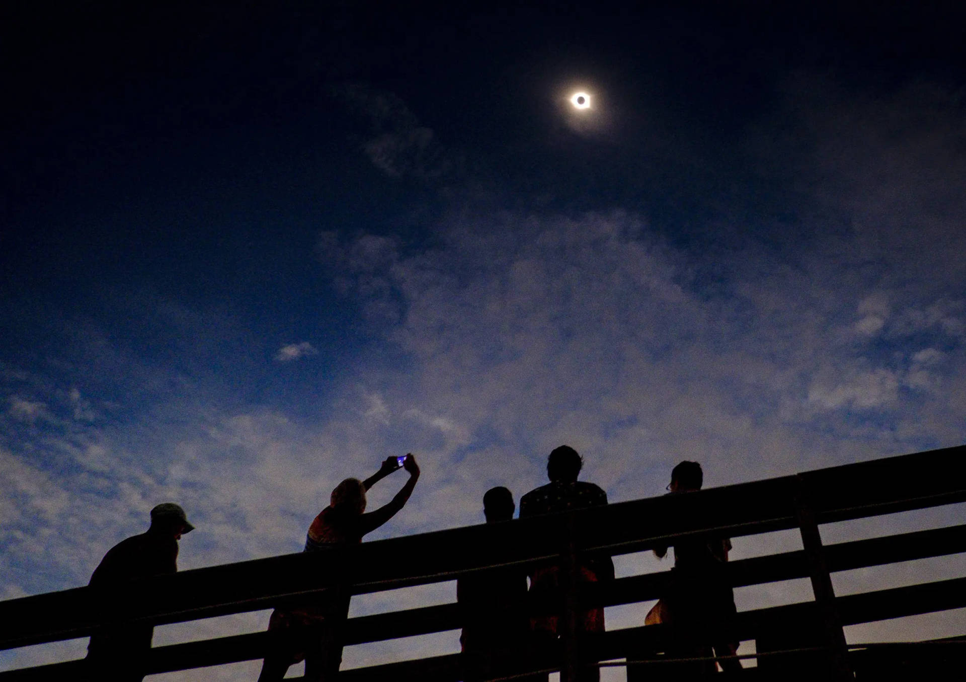 Spectacular View of Solar Eclipse Enjoyed by Crowd Wallpaper