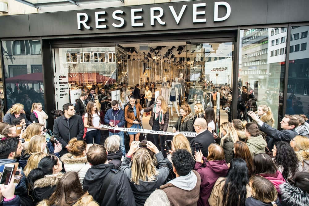 People Outside Reserved Clothing Shop Wallpaper