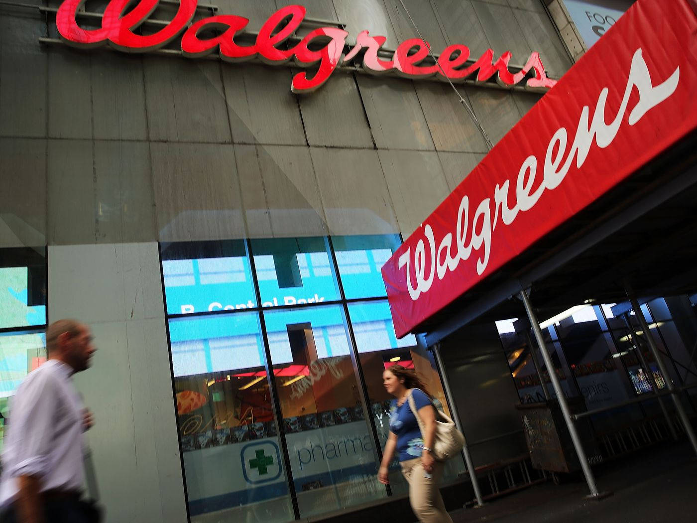 People Passing Walgreens Store Background