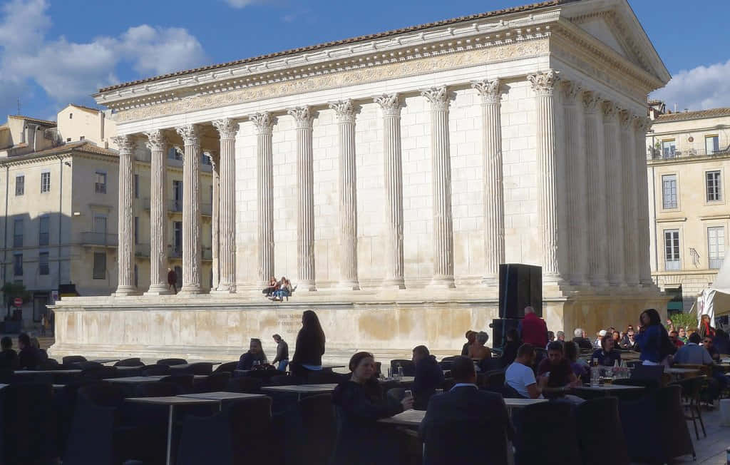 People Seated Around Maison Carrée Wallpaper