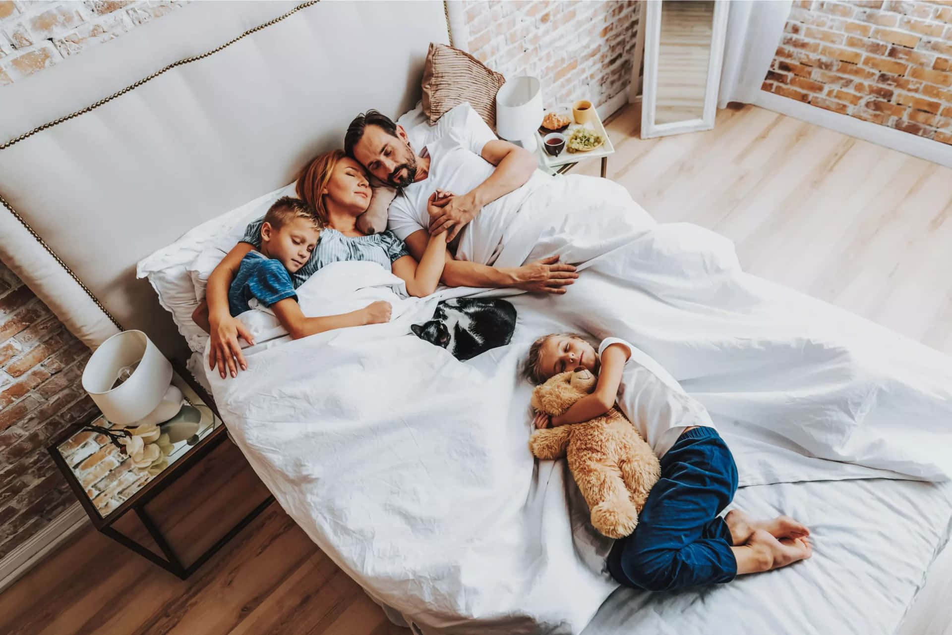 Family In Bed With Teddy Bears