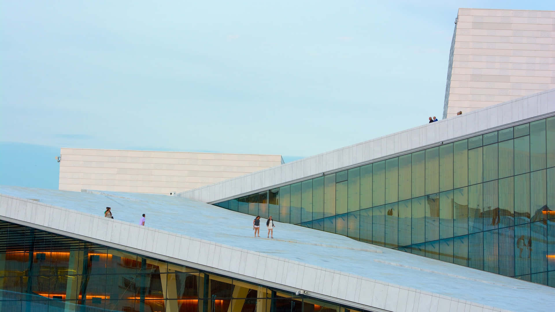 Breathtaking view of the Oslo Opera House bustling with people. Wallpaper