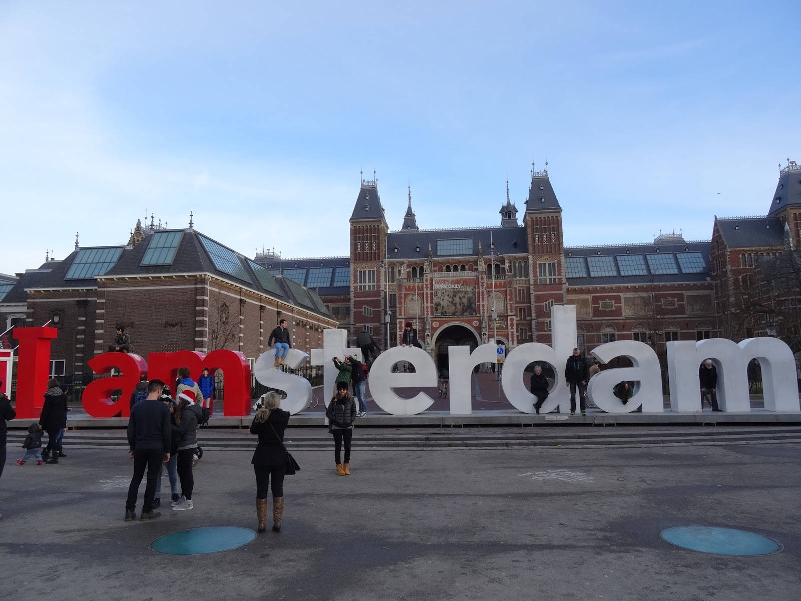 People With Amsterdam Sign Outside Rijksmuseum Wallpaper