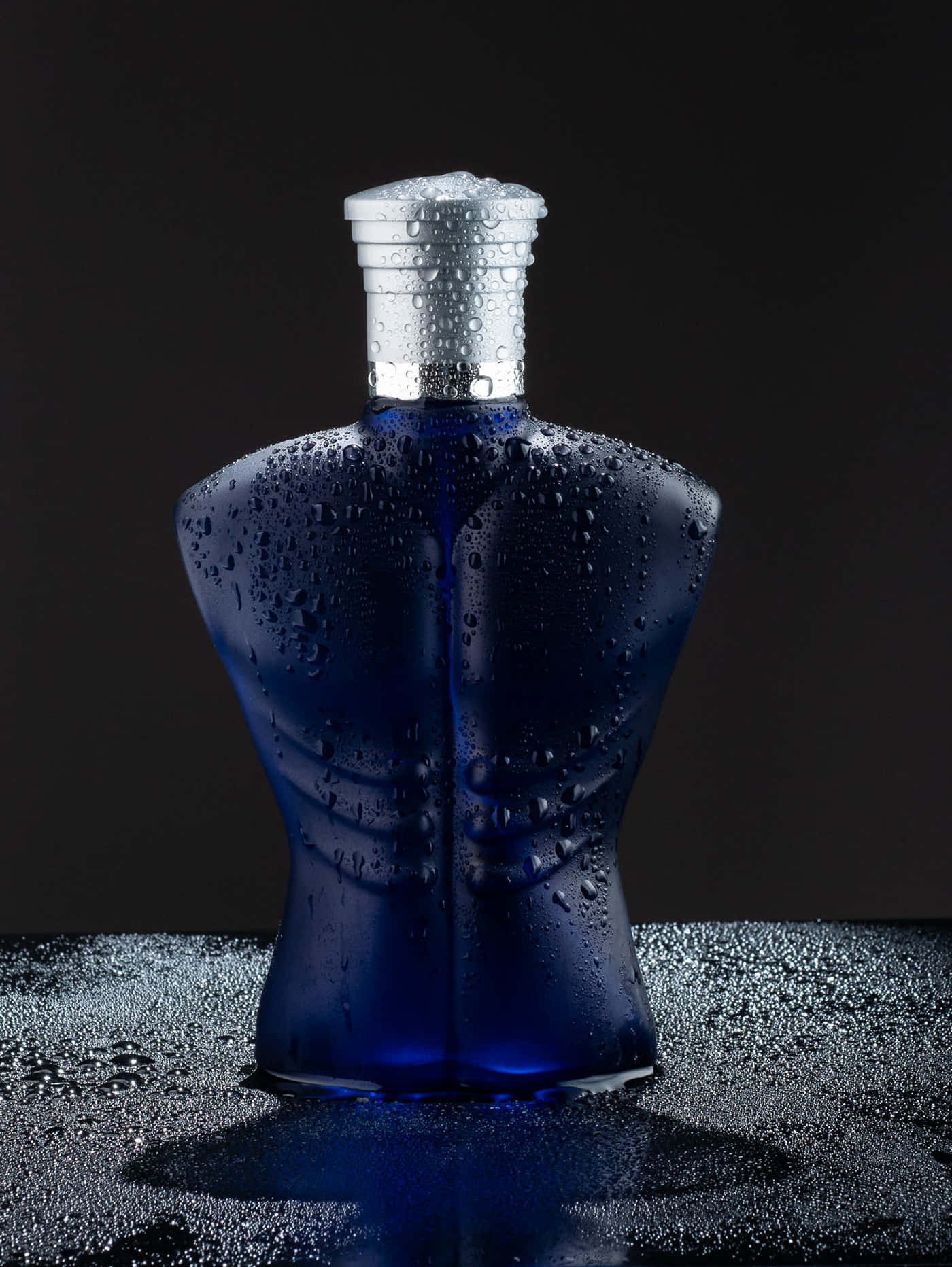 A Blue Bottle Of Perfume Sitting On A Black Background