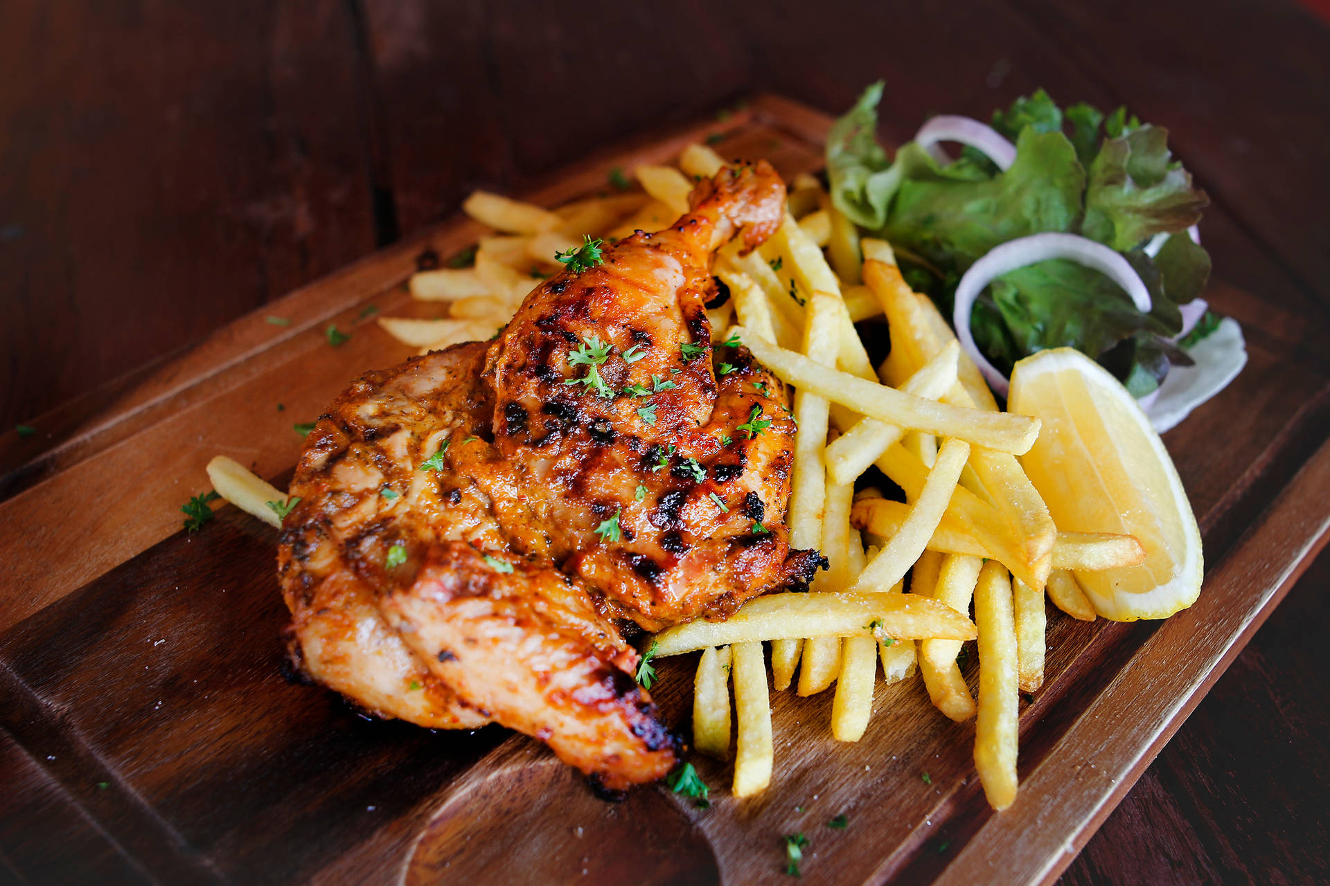 Peri Peri Chicken With Fries Topped With Parsley Wallpaper