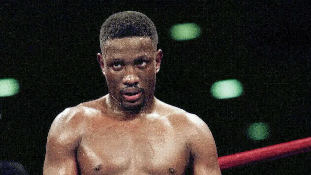 Legendary Boxer Pernell Whitaker Eyeing His Opponent in the Ring Wallpaper