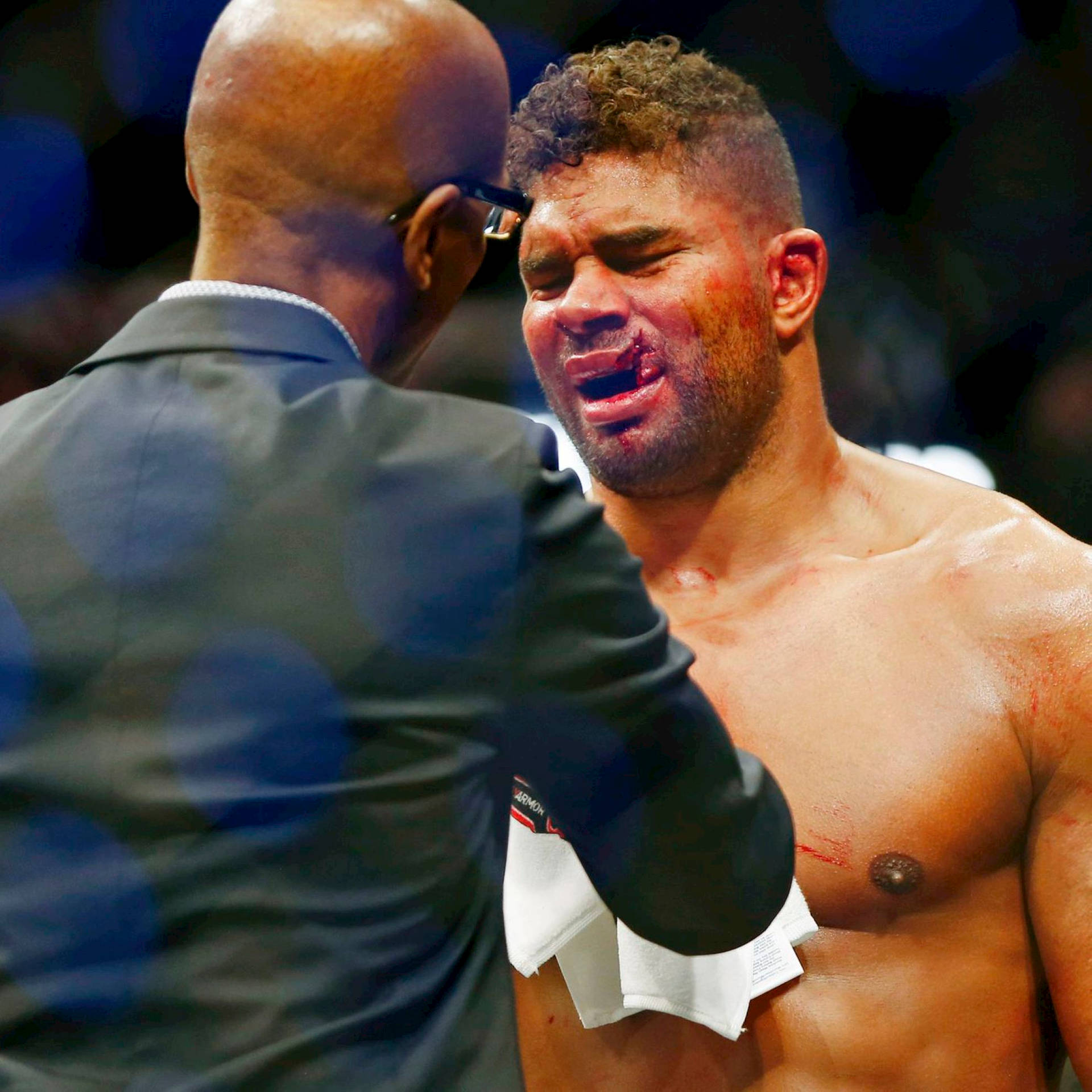 Person Checking Alistair Overeem Face Injury Wallpaper