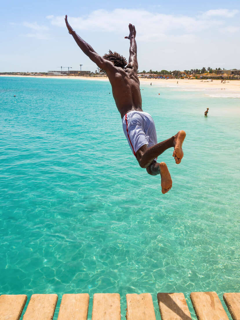 Person Jumping In Cape Verde Ocean Wallpaper