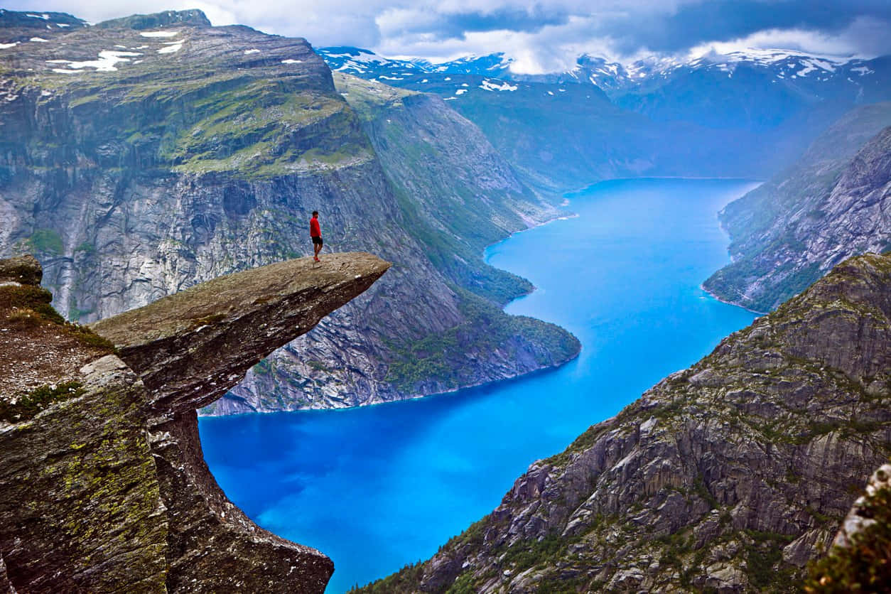 Person_on_ Trolltunga_ Overlooking_ Fjord.jpg Wallpaper