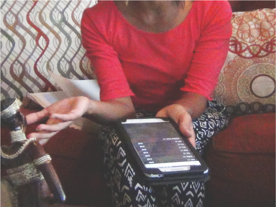 Person Using Tablet Indoors PNG