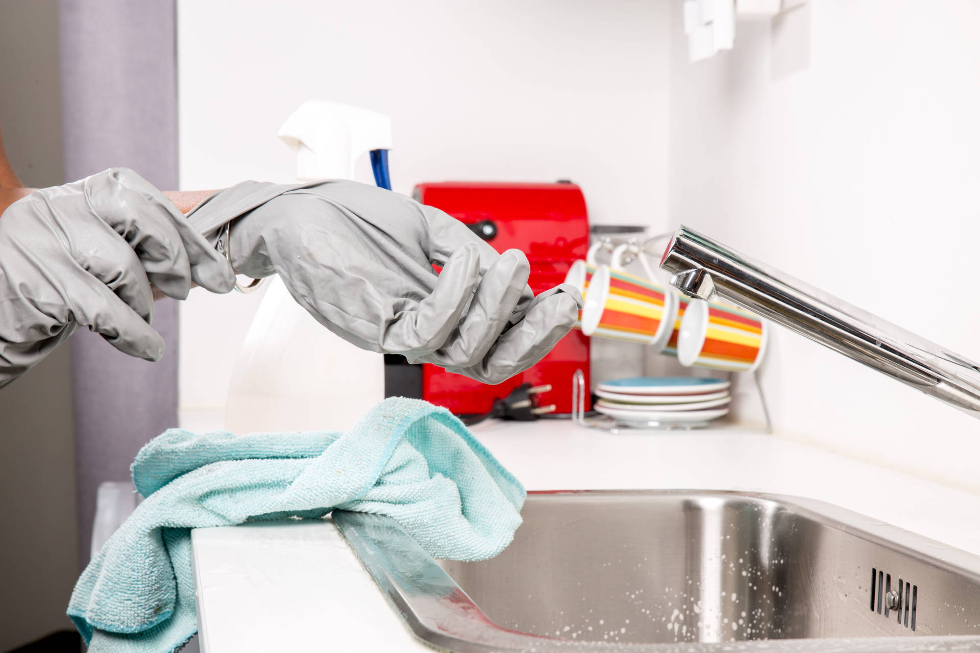 Person With Gray House Cleaning Gloves Wallpaper