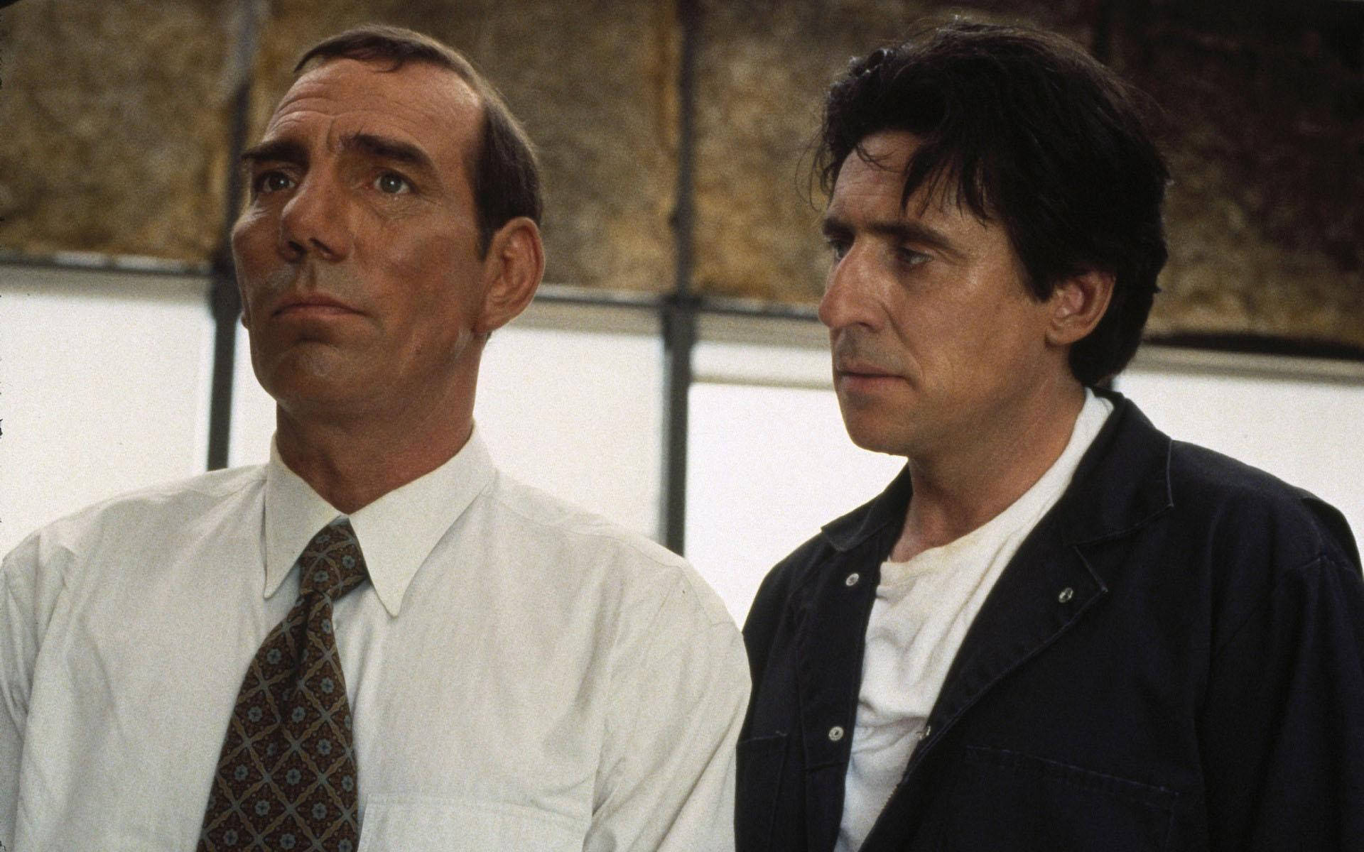 Renowned Actors Pete Postlethwaite and Gabriel Byrne in a Scene Wallpaper