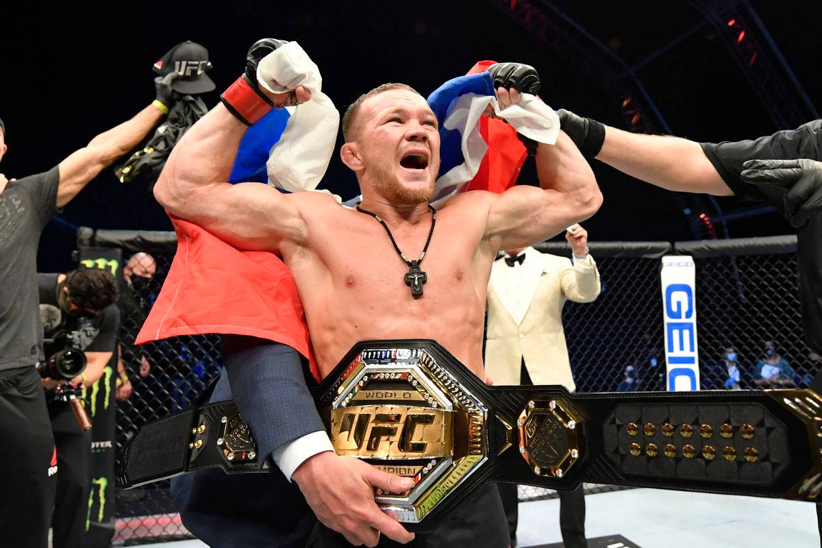 Petr Yan Celebrates Victory with UFC Champion Belt Wallpaper