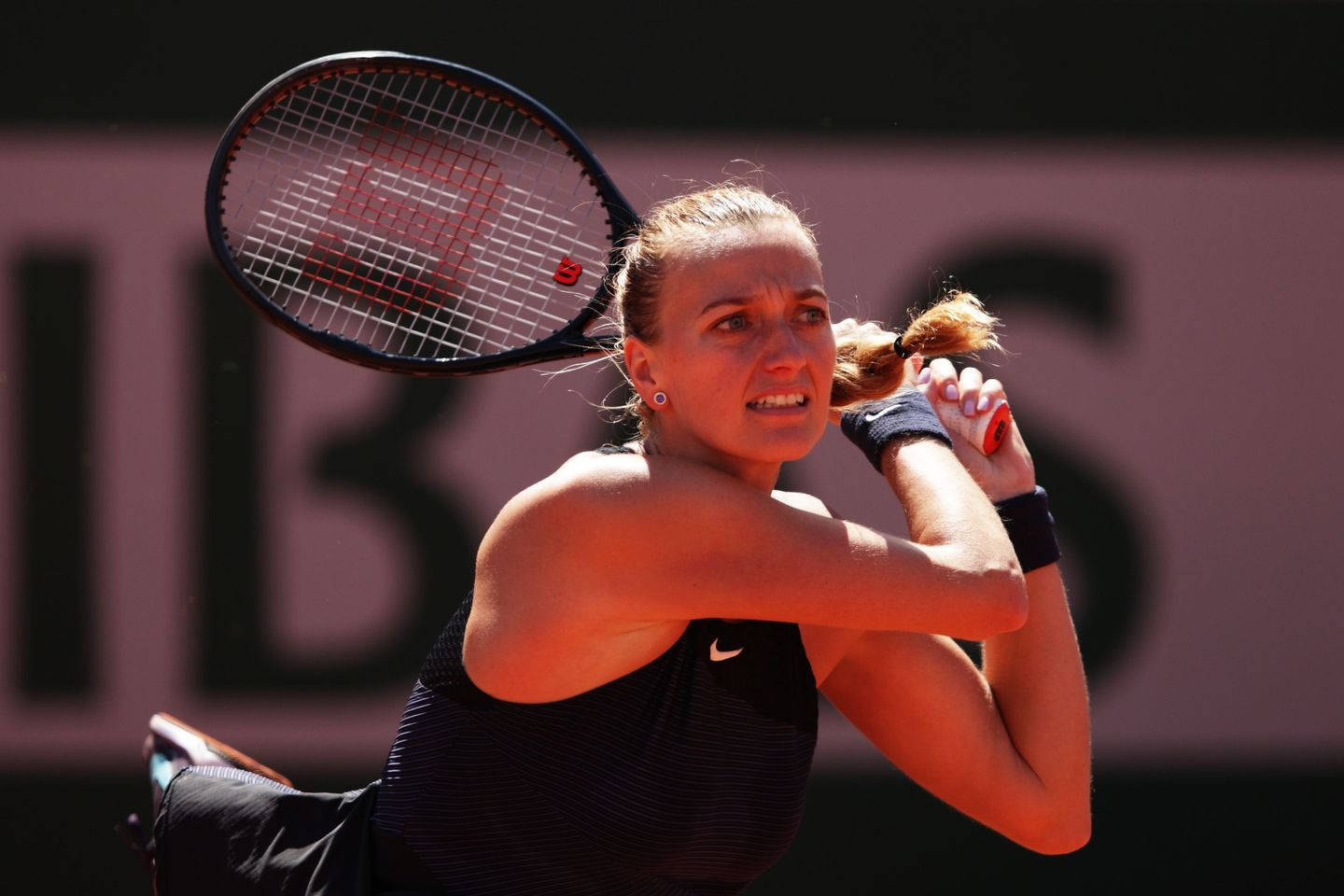 Caption: Petra Kvitova in action with her tennis racket Wallpaper