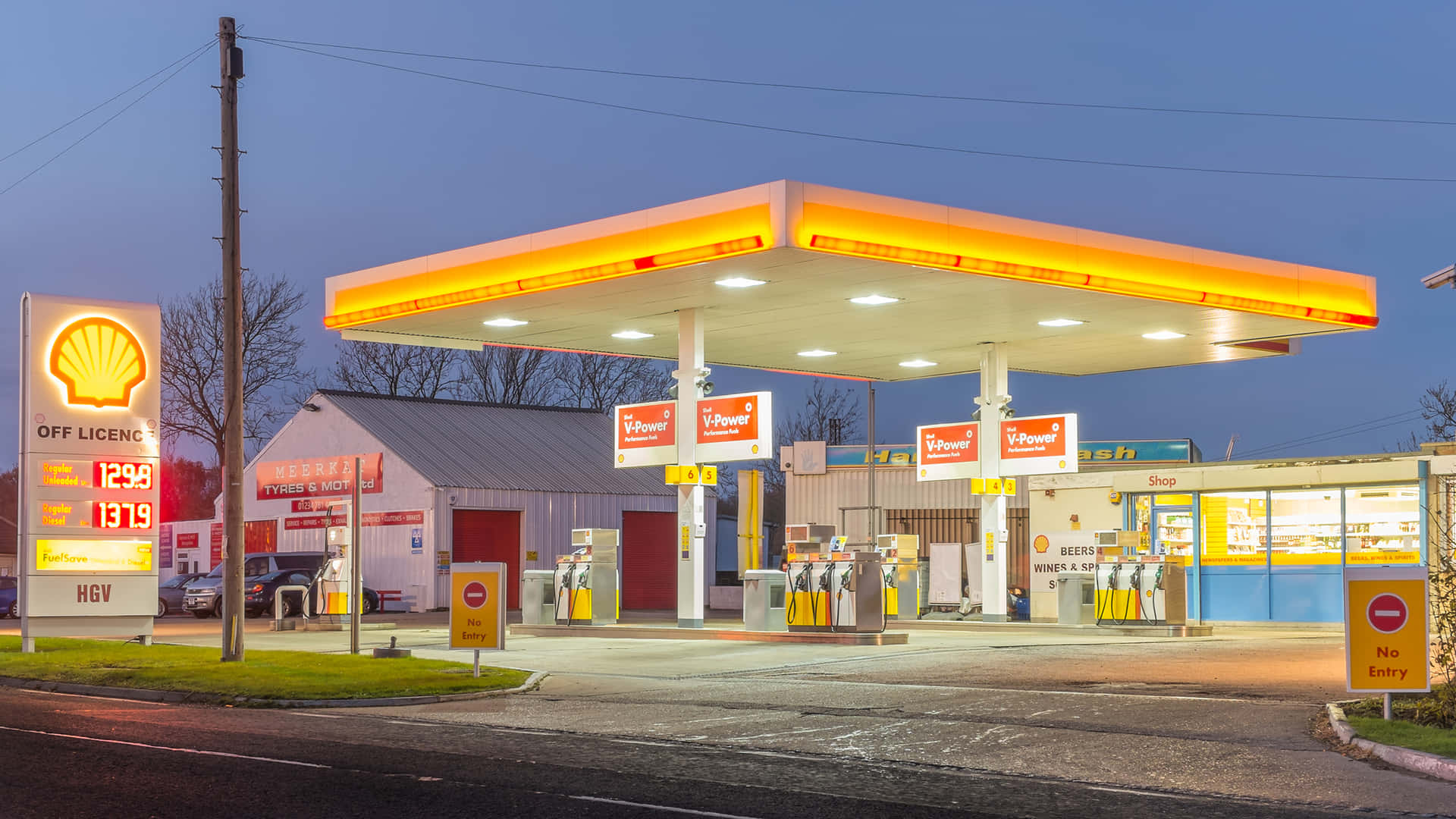 A Gas Station With A Yellow And Orange Sign