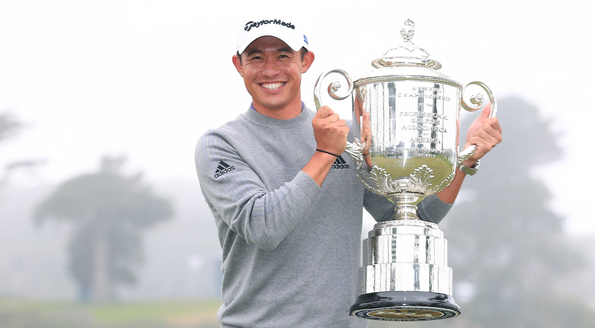 Collin Morikawa holding his PGA Trophy triumphantly Wallpaper