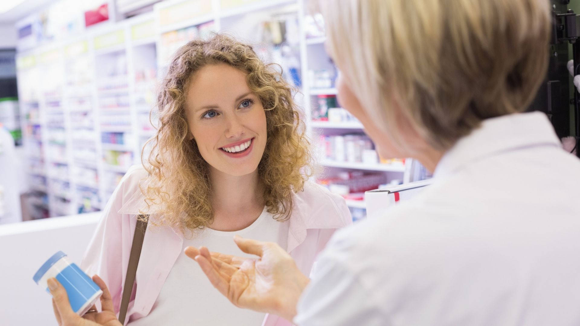 Pharmacist Explaining Medications To Client Wallpaper