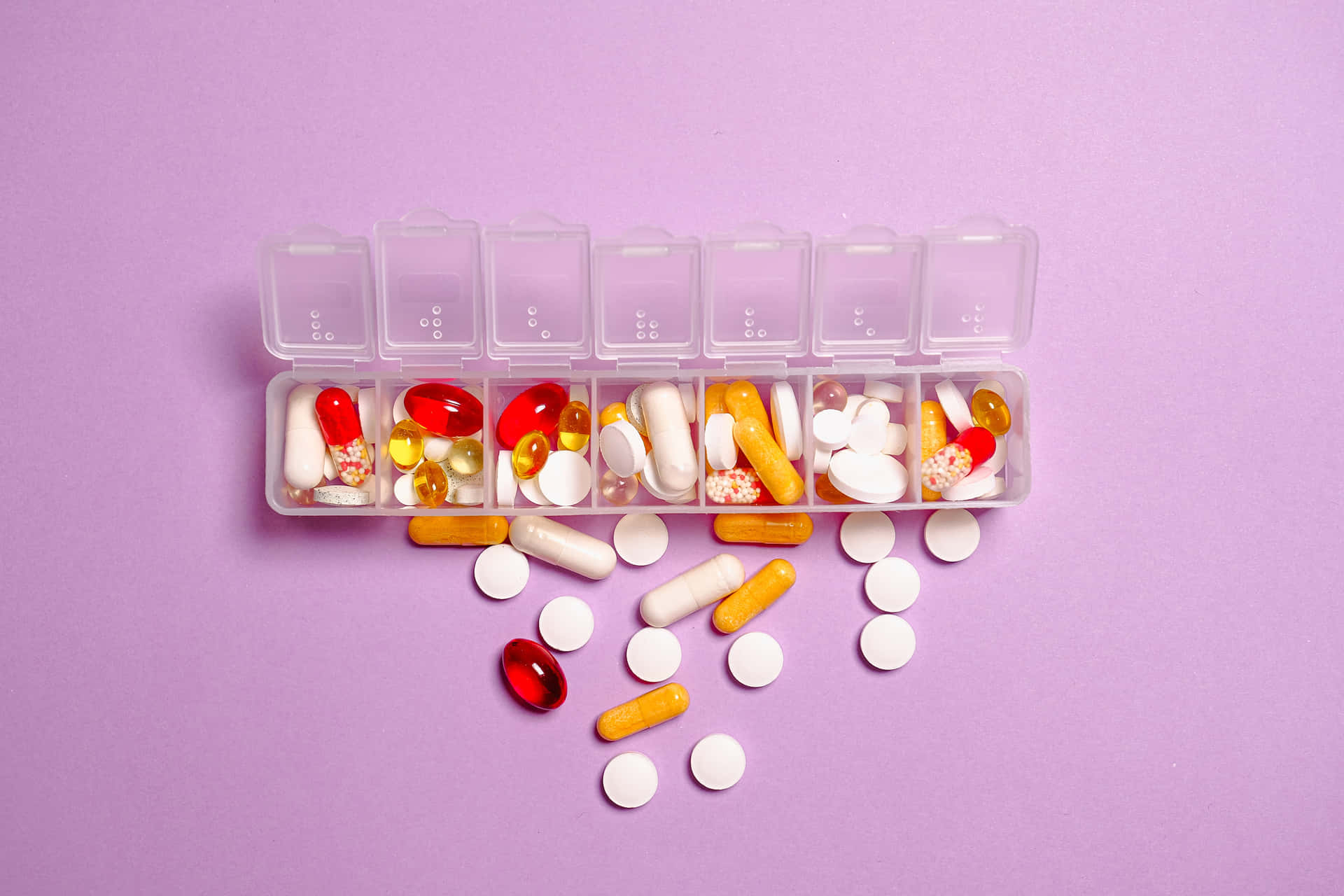 A Plastic Container With Pills And Pills On A Purple Background