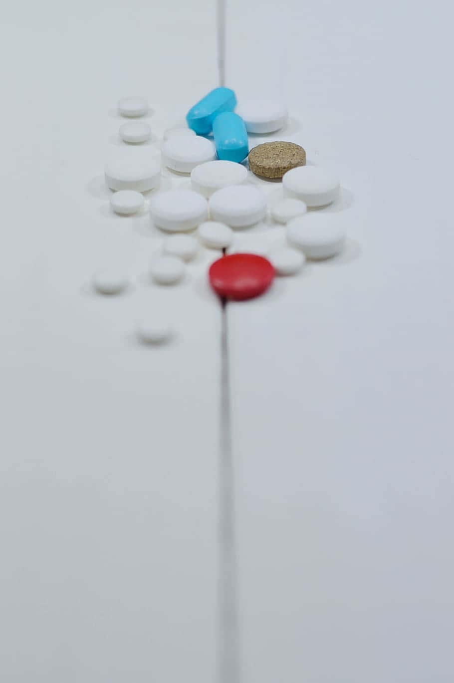 A Line Of Pills On A White Surface
